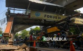 Sebuah truk yang mengangkut alat berat tersangkut di jembatan penyeberangan orang (JPO) di Jalan Tendean, Jakarta, Selasa (14/7/2026). Insiden yang terjadi sekitar pukul 01.00 WIB tersebut menyebabkan JPO mengalami kerusakan parah sehingga tidak dapat digunakan. Hingga pukul 10 pagi proses evakuasi truk dan JPO belum dilakukan karena memerlukan peralatan khusus. Akibat kejadian tersebut, arus lalu lintas di sekitar lokasi sempat mengalami kemacetan dan akses JPO ditutup sementara demi keselamatan masyarakat.