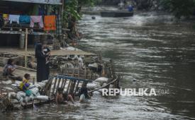 Warga mengamati anak-anak bermain di bantaran Sungai Ciliwung di kawasan Manggarai, Jakarta, Kamis (9/10/2025). Pemerintah Provinsi (Pemprov) Jakarta berencana melakukan normalisasi tiga sungai untuk mengatasi banjir pada tahun ini. Tiga sungai yang bakal dinormalisasi adalah Ciliwung, Krukut, dan Cakung Lama, yang merupakan sungai-sungai utama di Jakarta.
