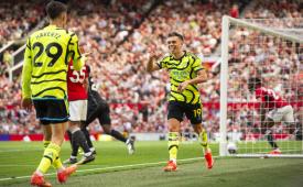   Leandro Trossard of Arsenal celebrates scoring the 0-1 goal with his teammtae Kai Havertz (L) who assisted the goal during the English Premier League soccer match between Manchester United and Arsenal in Manchester, Britain, 12 May 2024.  