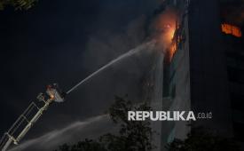 Petugas pemadam kebakaran berusaha memadamkan api yang membakar Gedung Badan Pendapatan Daerah (Bapenda) DKI Jakarta, di Jalan Abdul Muis, Jakarta, Jumat (7/8/2026) malam WIB.