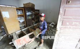 Seorang murid berada di dalam ruang guru yang rusak dan kotor akibat endapan lumpur di SDN 12 Desa Agusen, Blangkejeren, Gayo Lues, Aceh, Rabu (28/1/2026). Sekolah tersebut hingga saat ini belum mendapatkan bantuan penanganan sejak terdampak bencana hidrometeorologi pada akhir November 2025 lalu. 