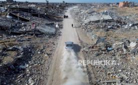 Warga Palestina berjalan melewati kehancuran akibat serangan udara dan darat Israel di Rafah, menyusul perjanjian gencatan senjata, Ahad 19 Januari 2025.