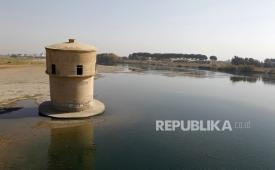 Pemandangan surutnya air sungai Efrat dekat kota Raqqa di Suriah timur, pada 2024 dengan tanda di menara observasi tua yang menunjukkan tingkat air yang lebih tinggi di masa lalu.