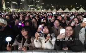 Para penggemar memperkenalkan saat grup K-pop BTS tampil selama konser BTS THE COMEBACK LIVE | ARIRANG di alun-alun Gwanghwamun di Seoul, Korea Selatan, 21 Maret 2026. 