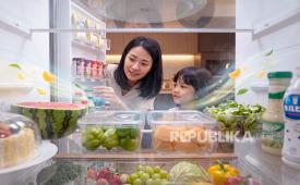 Ibu dan anak membuka kulkas (ilustrasi). Kulkas modern kini tak lagi sebatas menjaga suhu makanan tetap dingin, melainkan dirancang secara khusus untuk menciptakan ekosistem penyimpanan yang higienis, nyaman, dan presisi sesuai dengan karakteristik masing-masing bahan makanan.