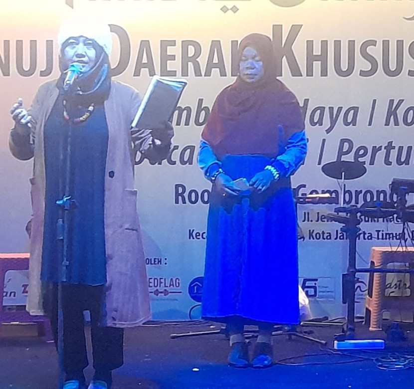 Penyair Perempuan Indonesia Nurhayati (dari Rumah Baca Churria) bersama seorang rekan ikut dalam parade baca puisi di Rooftop Pasar Gembrong Baru, Jatinegara, Jakarta Timur, Rabu malam, 3 April 2024.  (Foto: Lasman Simanjuntak)