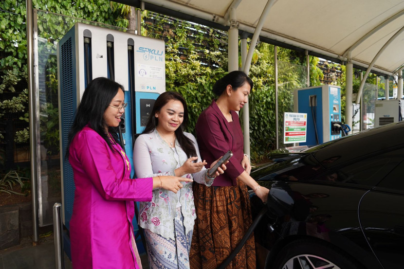 Srikandi PLN berbalut kebaya membatu pengendara kendaraan listrik mengisi daya di Stasiun Pengisian Kendaraan Listrik Umum. (Foto: Dok PLN)