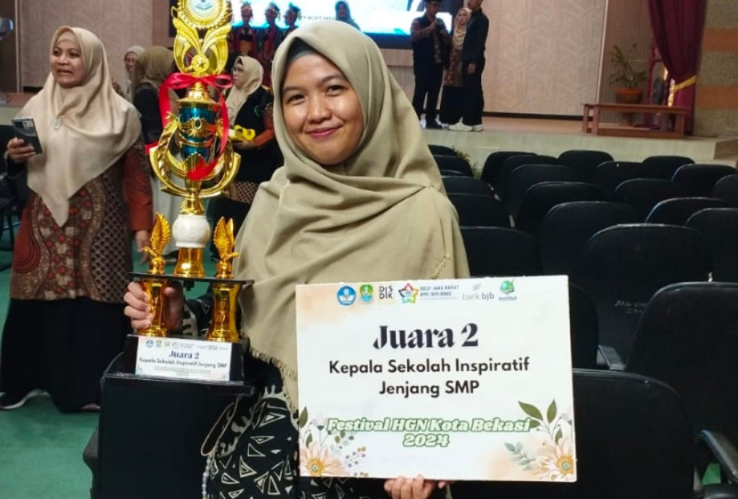 Kepsek SMP School of Human, Epong Utami menerima memenangkan Juara 2 dalam kategori Kepala Sekolah (Kepsek) Inspiratif tingkat Kota Bekasi. (Foto: Dok SMP School of Human)