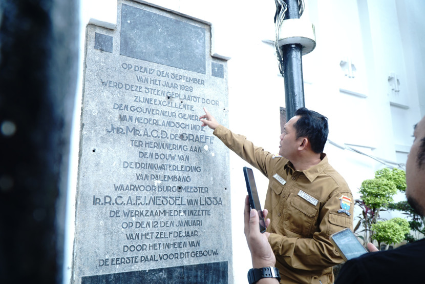 Pj Wali Kota Palembang Cheka Virgowansya menunjukkan prasasti yang ditemukan di dinding Kantor Wali Kota Palembang. (FOTO: D Oskandar)