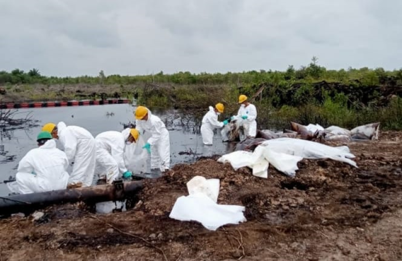 Pekerja Medco E&P membersihkan tumpahan minyak mentah akibat vandalisme. (FOTO: Humas Medco) 