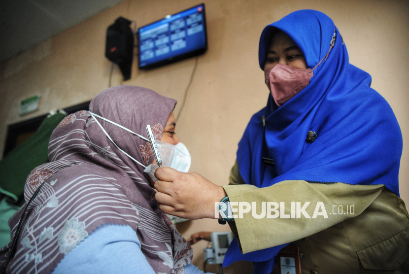 Nakes melakukan cek kesehatan warga. 