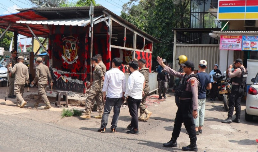 Aparat gabungan Polrestro Depok, TNI Kodim Depok dan Satpol PP Kota Depok melakukan penertiban bendera dan posko ormas di Kota Depok, Senin (19/05/2025). (Foto: Dok RUZKA INDONESIA)