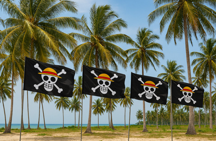 Bendera hitam Jolly Roger berkibar di pantai. (FOTO: AI)