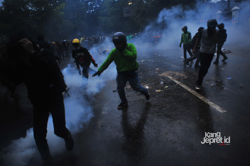 Pengunjuk rasa dari massa pengemudi ojol kocar-kacir akibat tembakan gas air mata di depan Gedung DPRD Jawa Barat, Jumat (29/8/2025). Mereka memprotes kematian Affan Kurniawan penemudi ojol yang dilindas Kendaraan Taktis (Rantis) Brimob di Jakarta. (KANGJEPRET.ID/YOGI ARDHI) (Nikon D3, Nikkor 20mm/2.8 D).