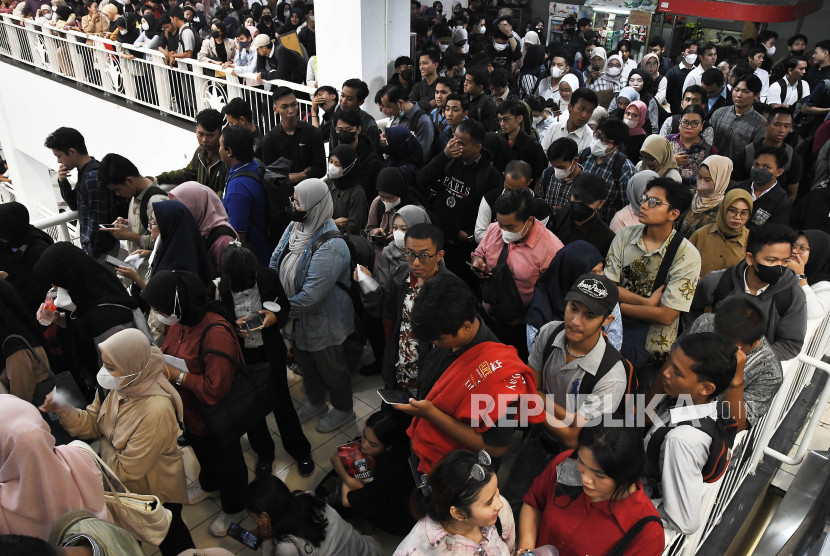 Sejumlah pencari kerja antre untuk memasuki area bursa kerja.