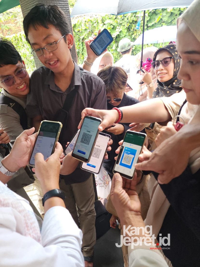 Salah satu anggota keluarga memindai koder QRIS saat pembagian Tunjangan Hari Raya (THR) keluarga besar RIS Abdul Rahman saat Idul Fitri 1447H/2025M di Bandung. QRIS (Quick Response Code Indonesian Standard) merupakan inovasi karya anak bangsa Indonesia yang diluncurkan oleh Bank Indonesia bersama Asosiasi Sistem Pembayaran Indonesia (ASPI) pada tahun 2019.(Foto Dokumen Keluarga)