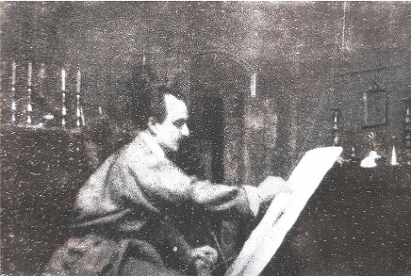 Khalil Gibran sedang melukis.