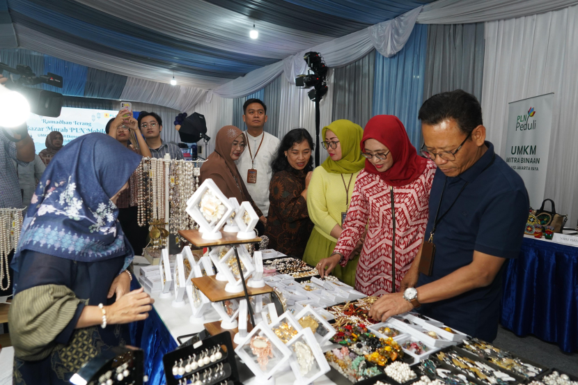 General Manager PLN UID Jakarta Raya, Lasiran (kanan) didampingi istri berkeliling lokasi bazar dan membeli produk-produk UMKM. (Dok. Matapantura.republika.co.id)