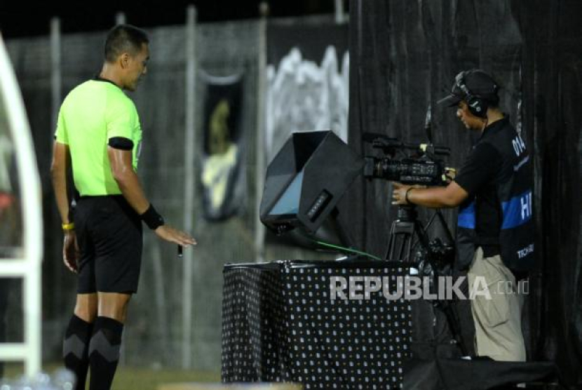 Wasit memeriksa kejadian melalui monitor Wasit Berbantuan Video (VAR) pada laga Persib vs Bali United. (Dok. Republika)