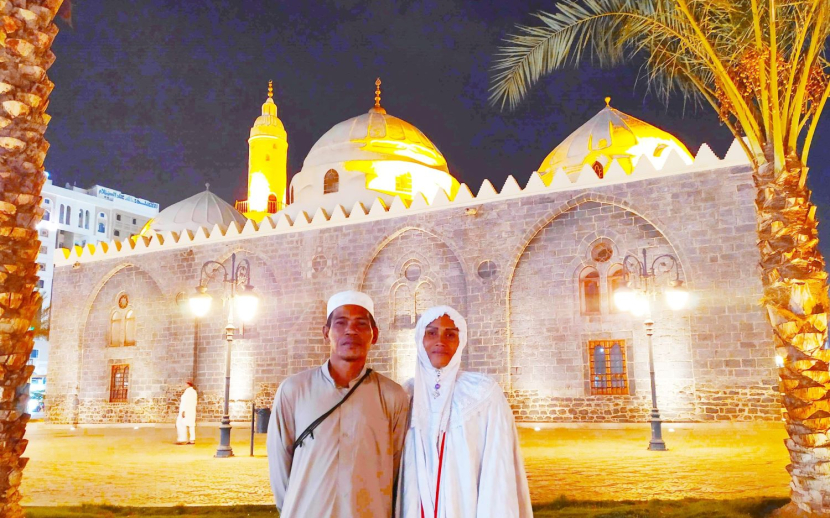 Pasangan suami istri jamaah haji asal Kaltim, berfoto bersama di depan Masjid Awan (Al-Ghamamah)