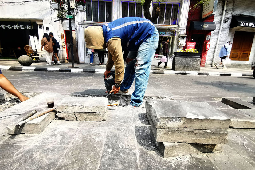 Pekerja kemudian memasang kembali batu andesit dengan permukaan yang lebih rata.