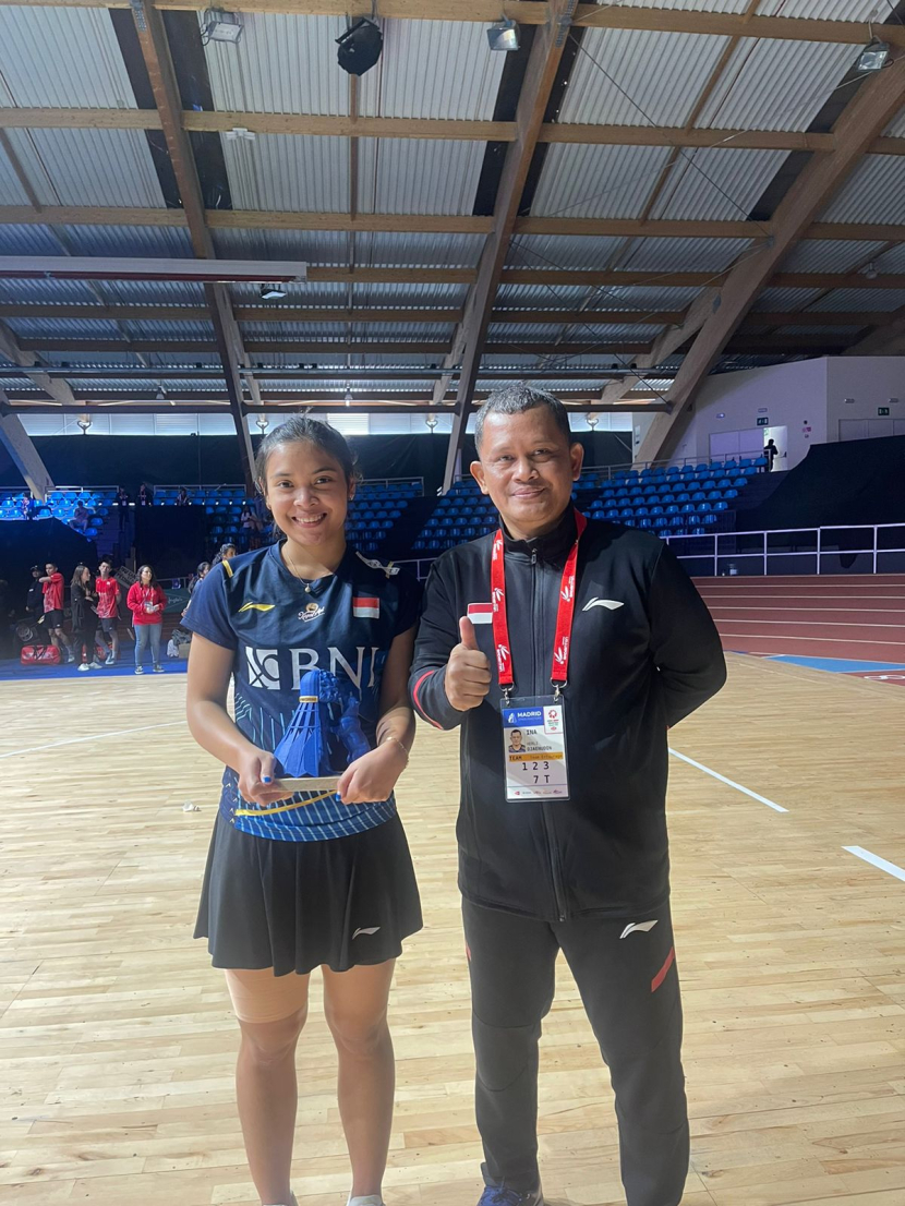 Gregoria Mariska Tunjung sebut gelar juaranya di Madrid Spain Masters 2023 merupakan sebuah penantian panjang. Gregoria dengan pialanya berfoto dengan pelatihnya, Herli Djunaedi.