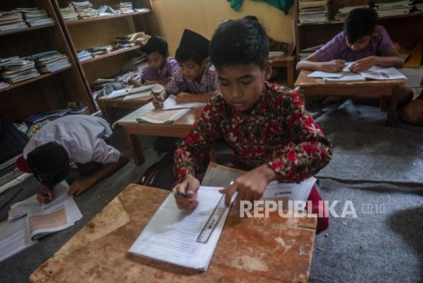 Siswa mengikuti kegiatan belajar mengajar (KBM) di SD Negeri 4 Cilaja, Pandeglang, Banten, Rabu (8/2/2023). Pihak sekolah menyebutkan para siswa terpaksa belajar di ruang perpustakaan tanpa menggunakan kursi karena tiga ruang kelasnya ambruk disebabkan angin kencang sehingga sejumlah fasilitas KBM rusak. On This Day: 2 Mei 1959, Ditetapkannya Hari Pendidikan Nasional. Foto: ANTARA FOTO/Muhammad Bagus Khoirunas/rwa