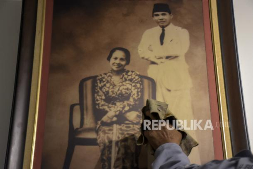 Petugas membersihkan foto Presiden Soekarno dengan Inggit Garnasih di Rumah Bersejarah Inggit Garnasih, Jalan Ibu Inggit Garnasih, Astanaanyar, Kota Bandung, Sabtu (4/3/2023). Foto: Republika/Abdan Syakura