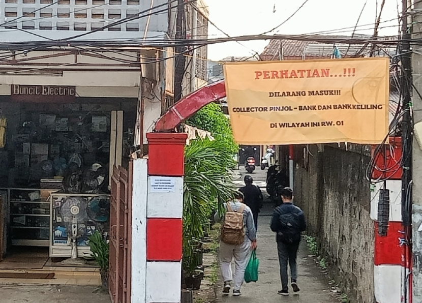 Peringatan di spanduk untuk debt collector (penagih utang) agar tidak memasuki kampung di Mampang Prapatan, dekat halte Transjakarta Mampang.