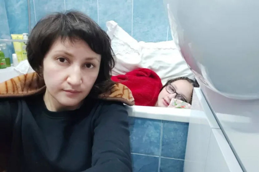 Since Saturday, Zakhida Adylova and her daughter have been sheltering in the bathroom of their Kyiv apartment while Zakhida's mother chooses to stay in the corridor of their home [Courtesy of Zakhida Adylova]